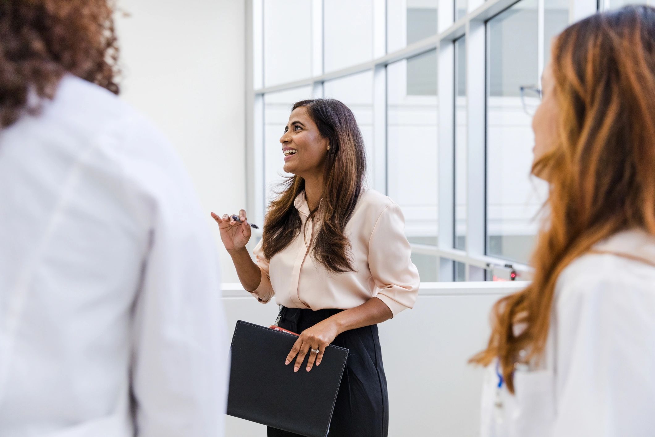 Hospital administrator discussing processes with medical staff